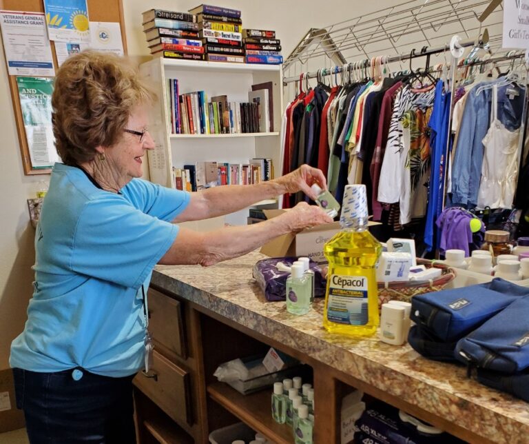 Volunteer Stocking the Hygiene Corner at the Community Caring Center